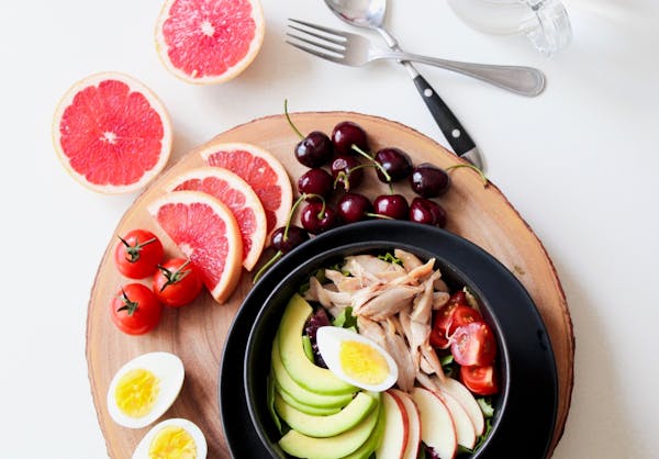 Colorful healthy meal with fruits, eggs, and avocado—balanced nutrition